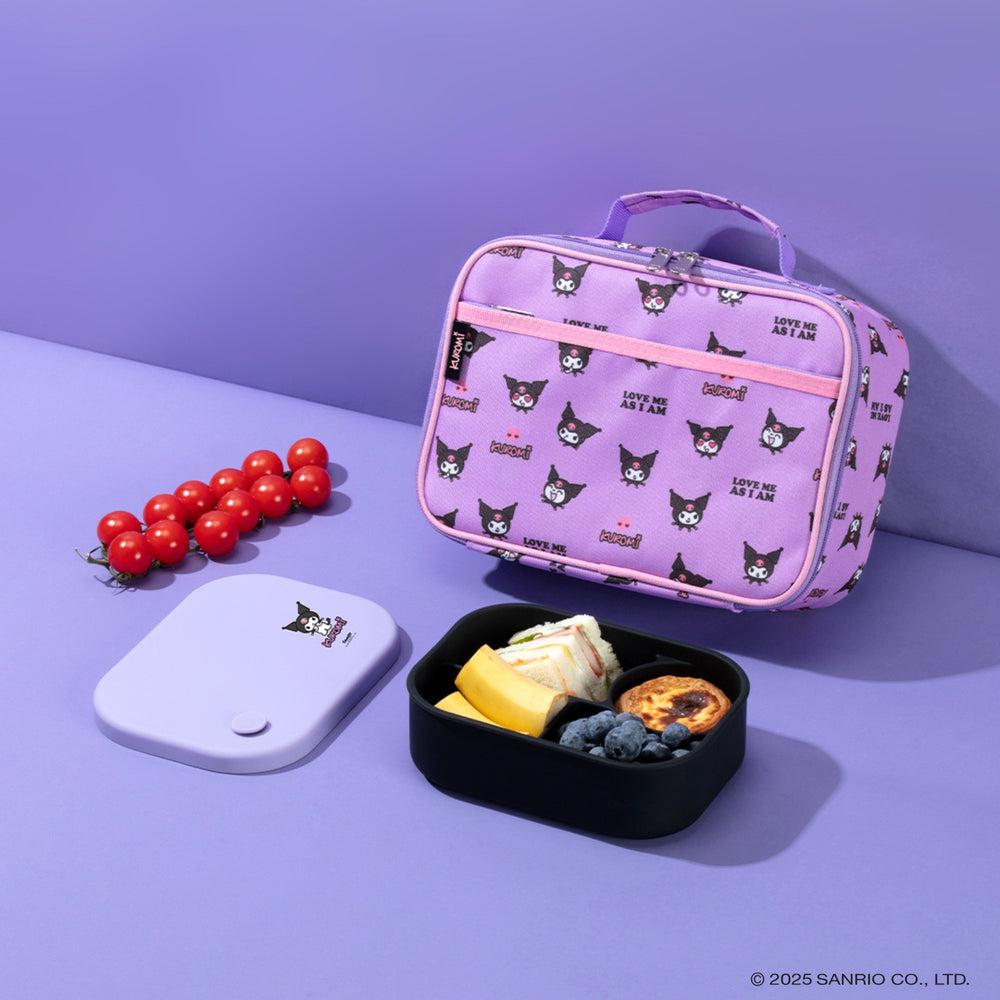 Purple lunch bag with cat pattern, bento box, and cherry tomatoes on a purple background. Bento buzz.