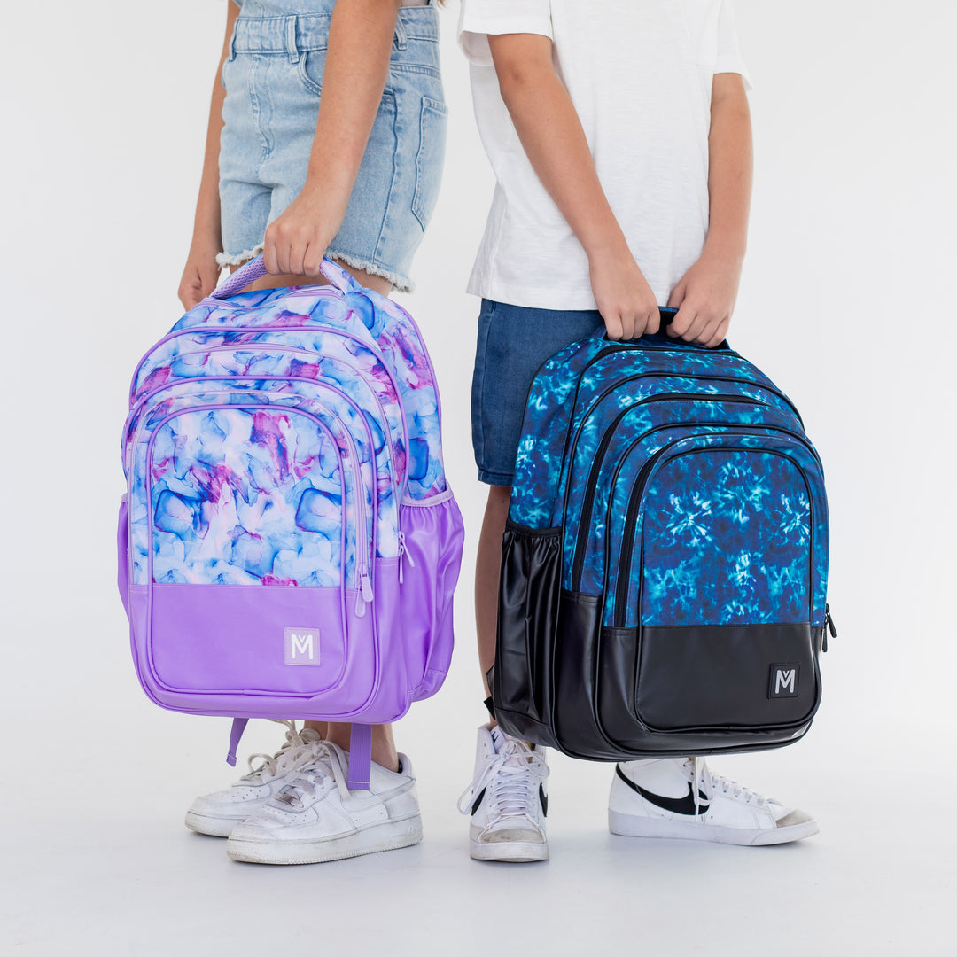 MontiiCo backpacks in Aurora, pinks and purples and Nova, Dark and Light Blues.